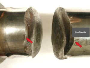 A low angle view of the fractured input shaft points to the fracture origin at the dot peened "0" in the date code.
